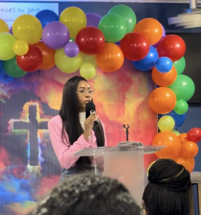 Jada speaking to an audience at a church event